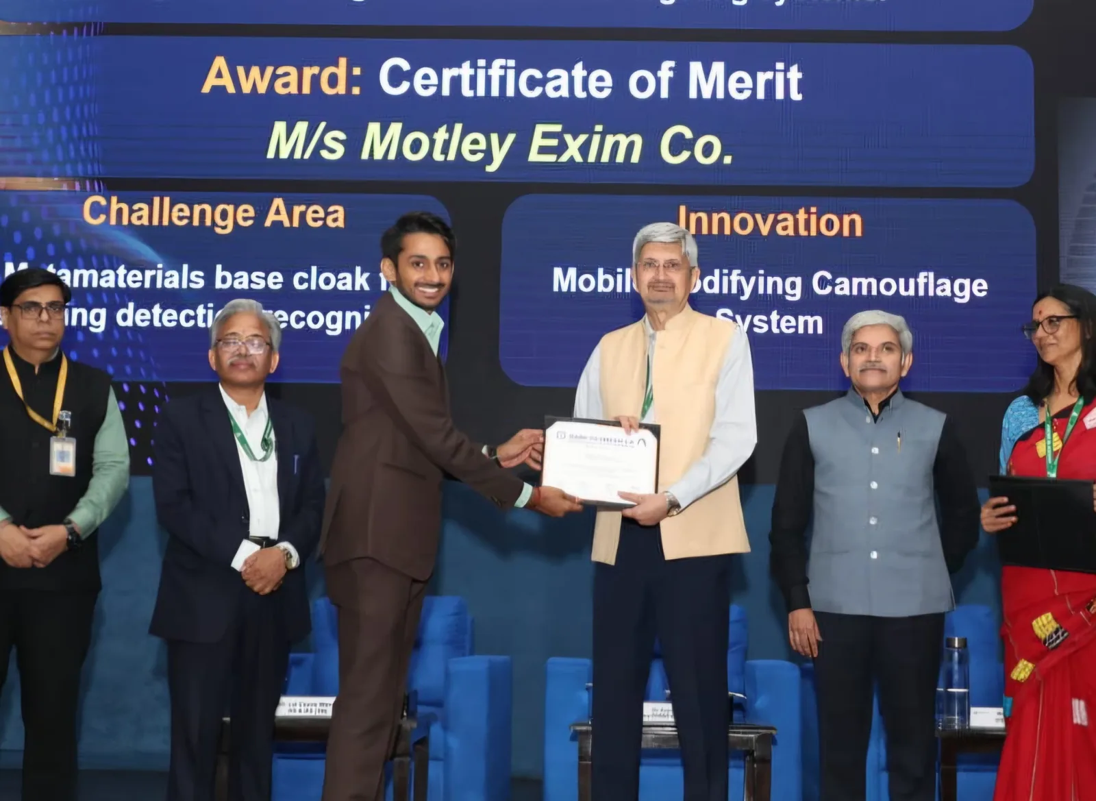Mr. Tejasvi Shedha of Motley Exim Co. receiving the DRDO Dare to Dream 5.0 Certificate of Merit from Dr Samir V Kamat, Chairman DRDO, on stage at the award ceremony.