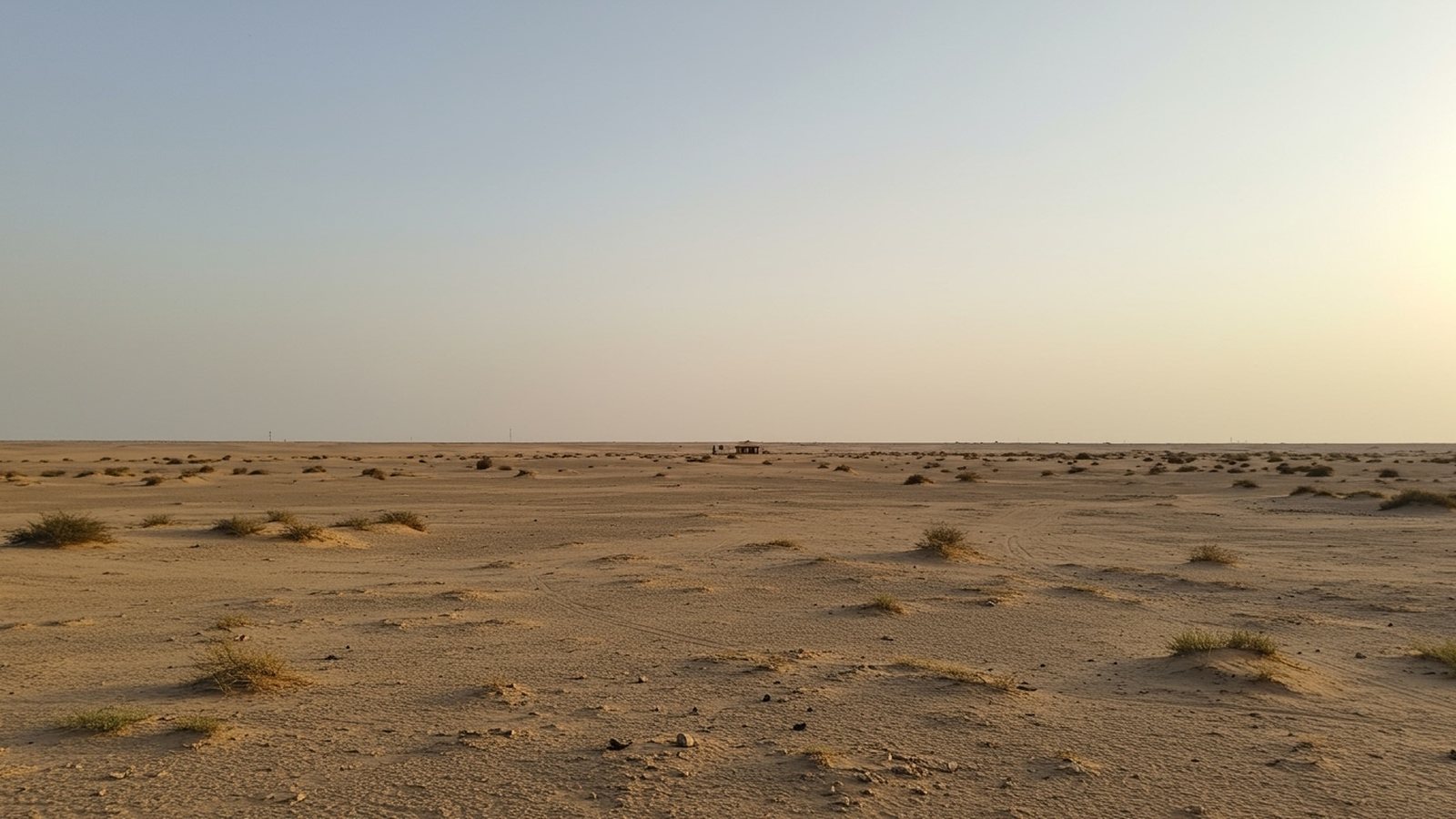 CAMPRO multi-spectral desert camouflage net concealing equipment in arid sand terrain
